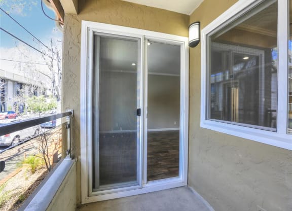 A glass door is in the middle of a concrete floor.