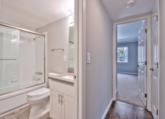 A bathroom with a toilet, sink, and shower.