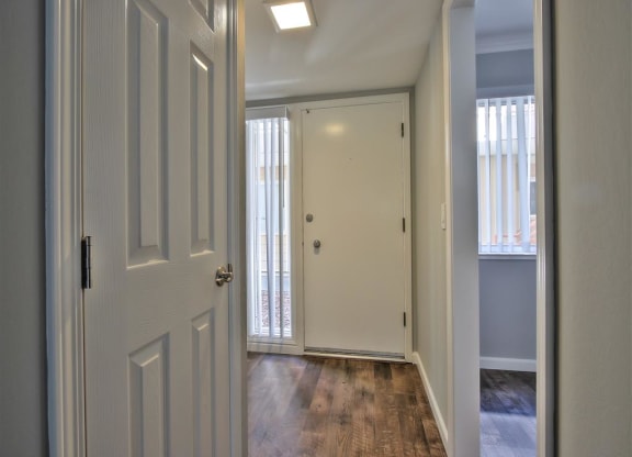 A white door is open to a hallway.