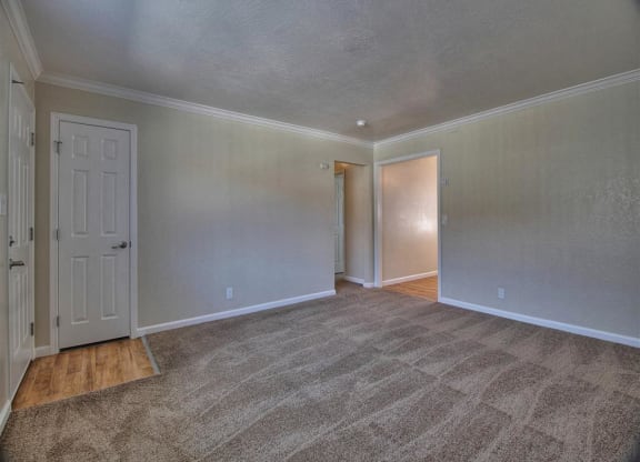 the living room of an empty house with a white door