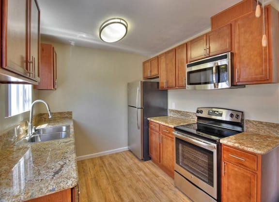 a kitchen with stainless steel appliances and wooden cabinets