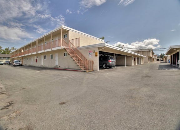 A parking lot with a building in the background.