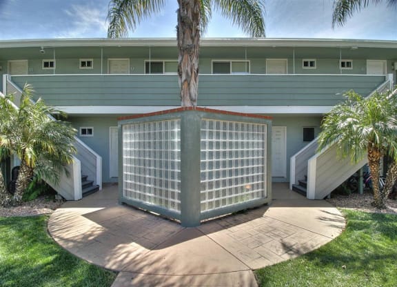 A building with a glass enclosed structure in the front yard.