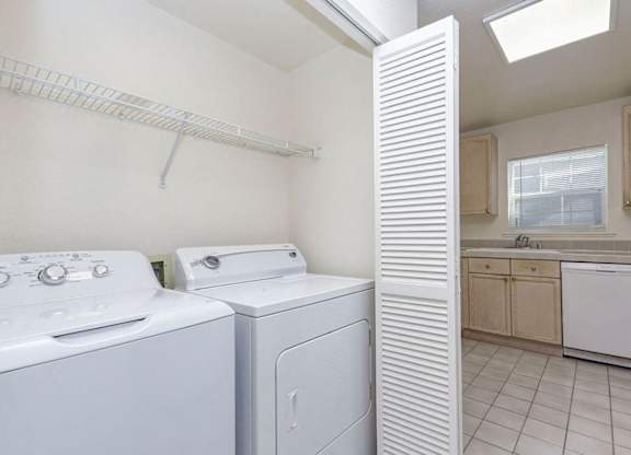A white laundry room with a washer and dryer.