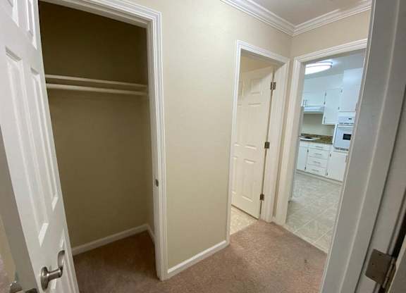 A white door is open to a hallway.