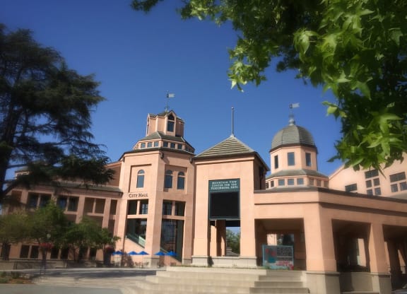a large building with three towers in front of a blue sky