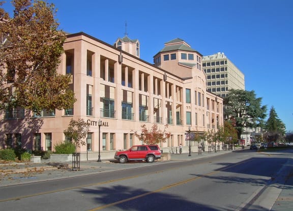 a red car parked in front of a building on a street