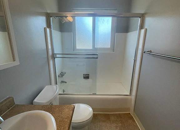 a bathroom with a sink toilet and a shower
