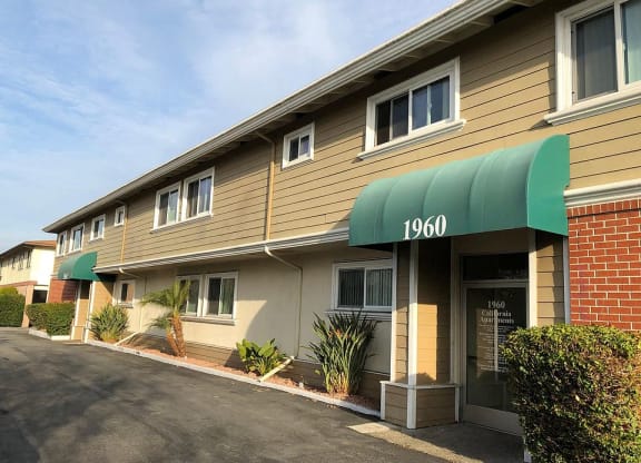 the front of a building with a green awning