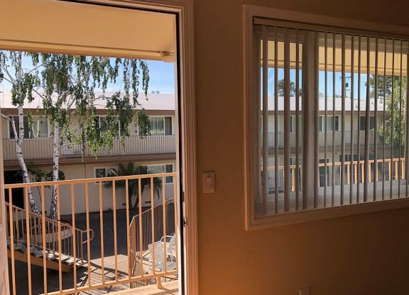 a view of a balcony and a door with a window