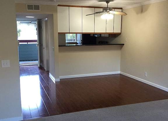 A room with a ceiling fan and a window.