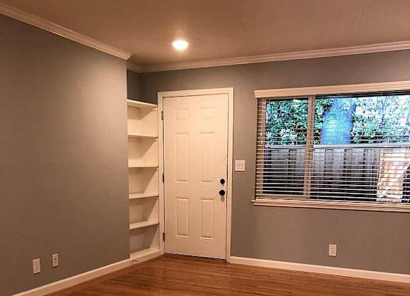 A room with wooden floors and a white door.