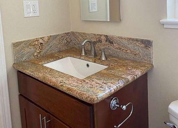 a bathroom with a sink and a mirror
