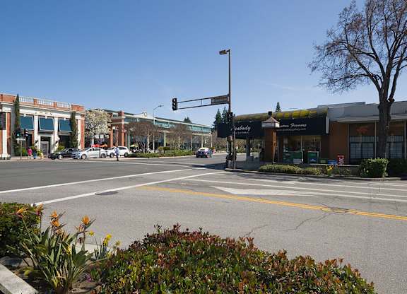 an empty street with a traffic light at an intersection