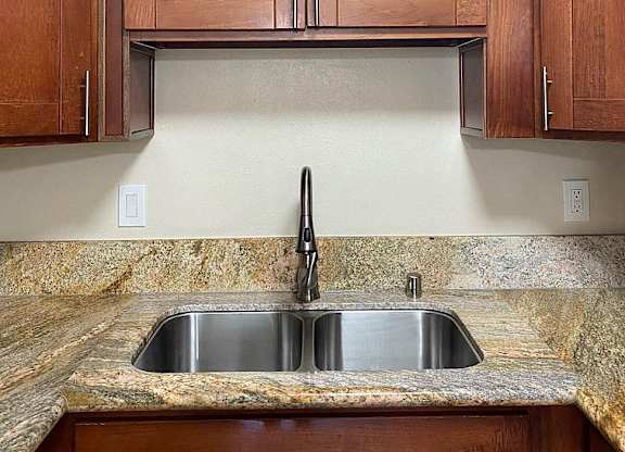 a kitchen with a sink and wooden cabinets
