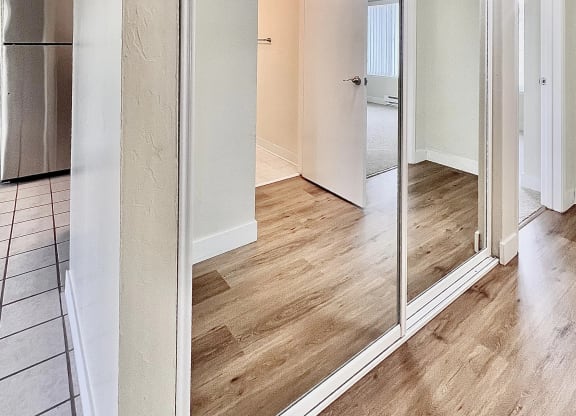 a sliding glass door in a living room with a kitchen