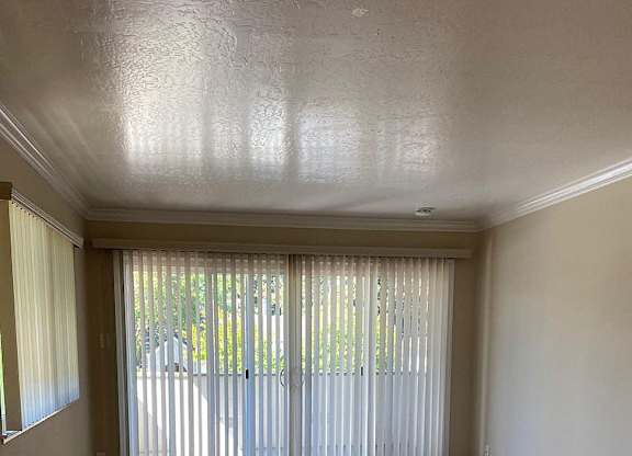 an empty living room with sliding glass doors