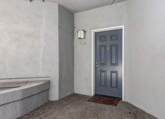 A grey door with a number 110 on it.