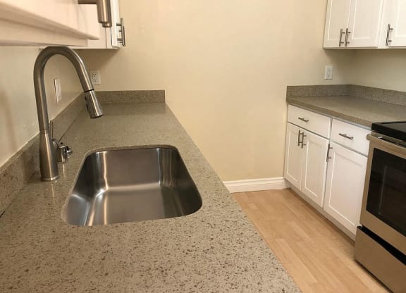 a kitchen with a stainless steel counter top and a sink