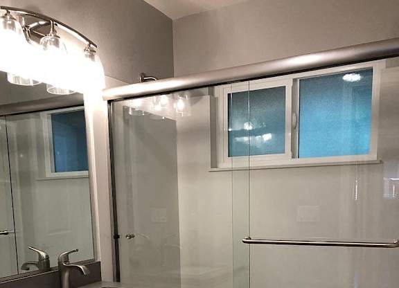 A bathroom with a sink, toilet, and shower.