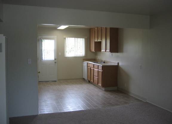 A kitchen area with a sink and cabinets.