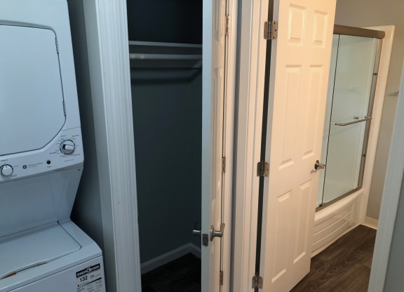 a laundry room with a washer and dryer and a closet