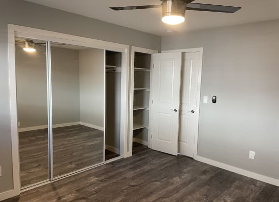 A room with a sliding door and a ceiling fan.