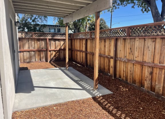 A wooden fence with a concrete slab in the middle.
