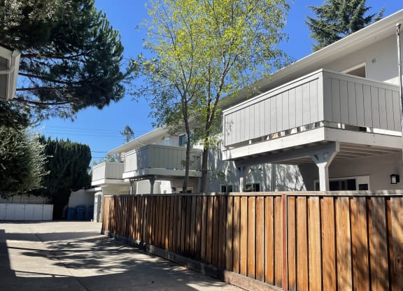 A modern house with a wooden fence in front.