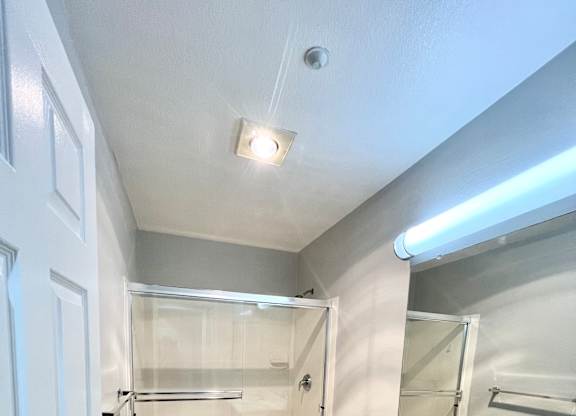 A bathroom with a white sink and a toilet.