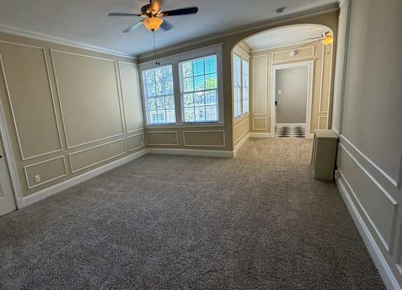 a look down the stairs of a house with wooden floors and white walls