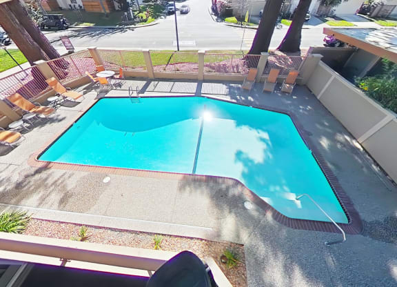 A small rectangular pool with a white fence around it.