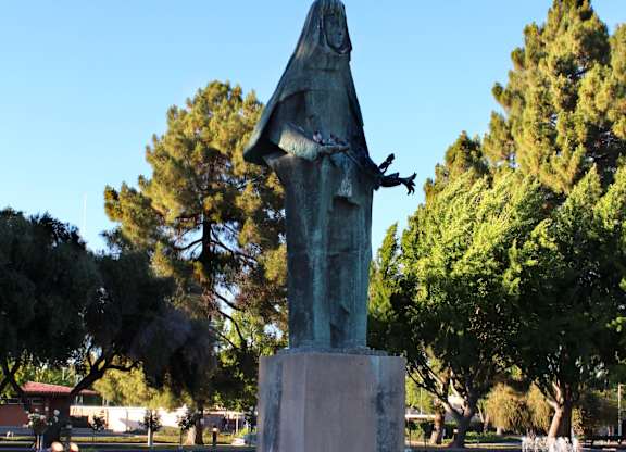 a statue in a fountain in a park
