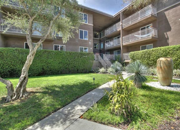 Full greenery outside with exterior building view at The Luxe, Santa Clara, 95051