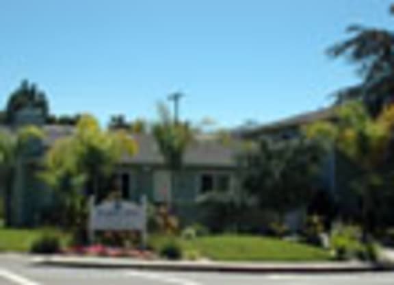a house with a yard and a street in front of it
