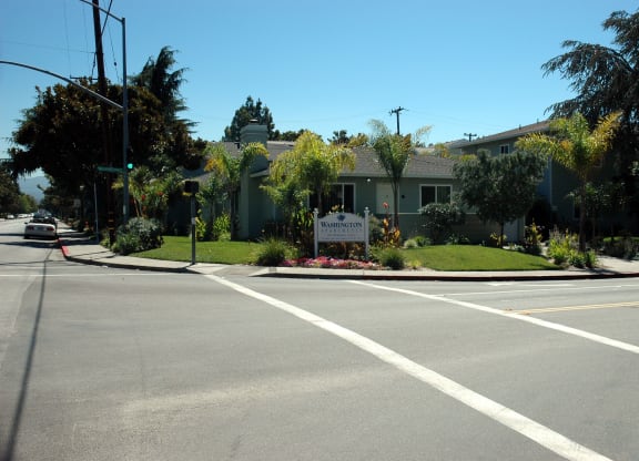 an empty street in front of an apartment building