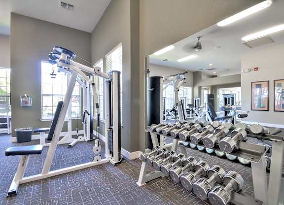 Fitness center with free weights and equipment at Rosemeade Apartments, California