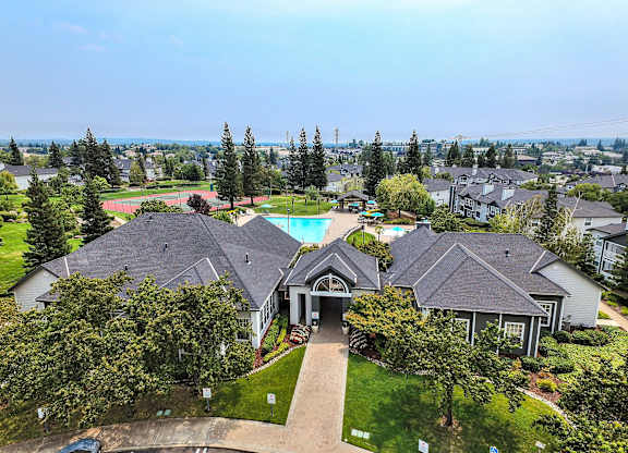 Aerial view of community clubhouse and pool area at Rosemeade Apartments, California