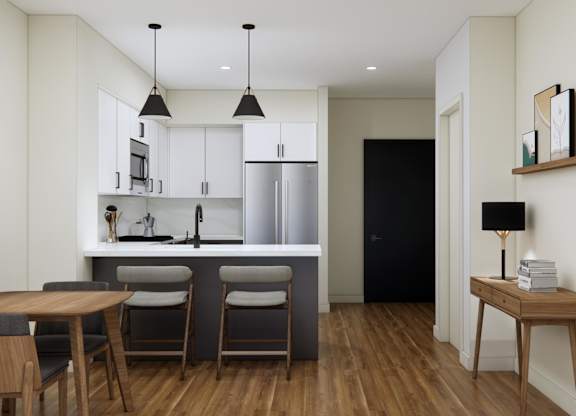 A modern kitchen with a dining table and chairs.