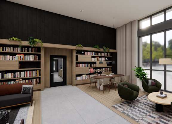 A modern living room with a large window, a bookshelf, and a green armchair.