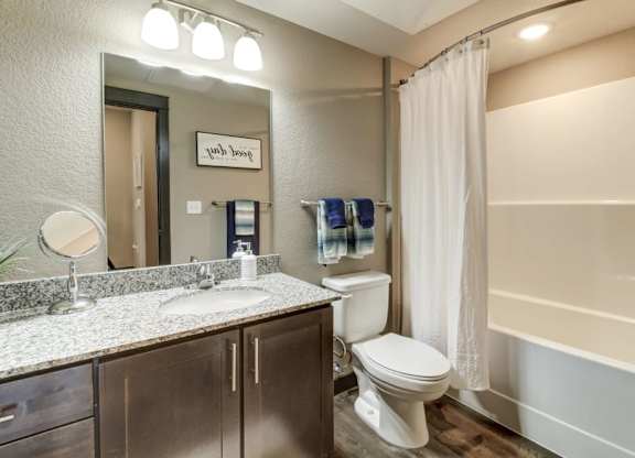 A bathroom with a toilet, sink, and bathtub.