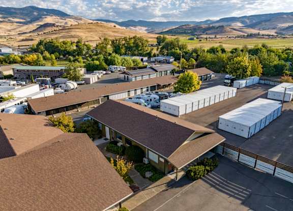 A large building complex with a parking lot in front.