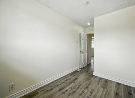 A room with a wooden floor and white walls.