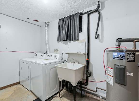 A bathroom with a washer and dryer.