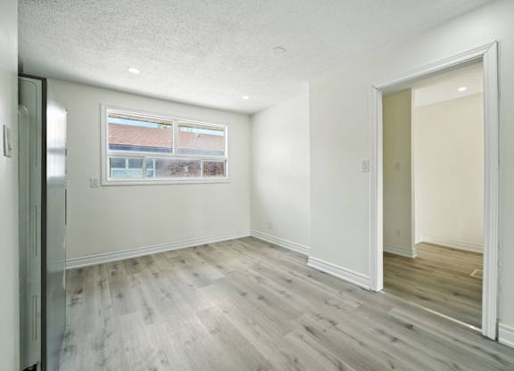 A room with a window and a door.