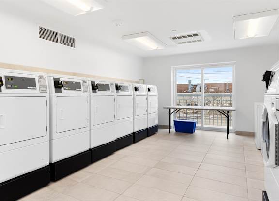 A laundromat with rows of washers and dryers.