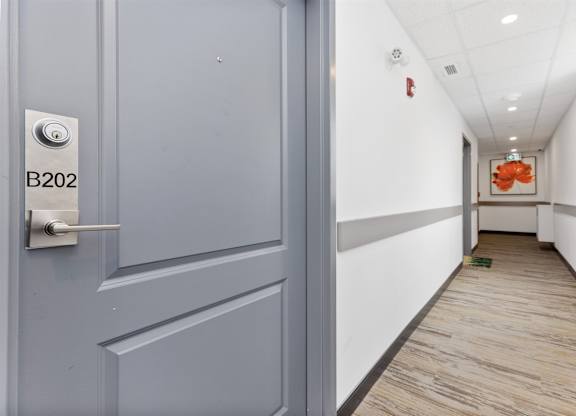 A hallway with a door labeled B202.