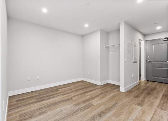 A room with a wooden floor and white walls.