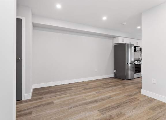A kitchen area with a refrigerator and a dishwasher.