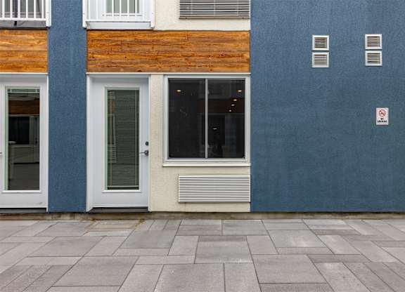 A building with a blue wall and a white door.